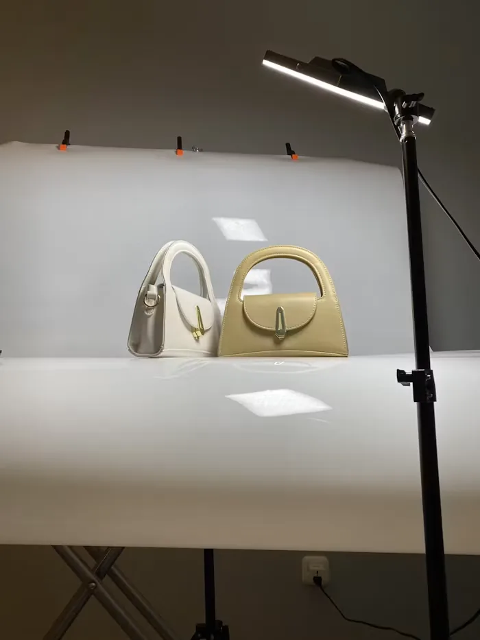 Handbags arranged on a table in a small studio