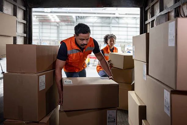 Two workers packing orders into cartons